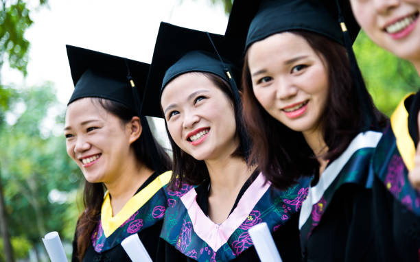 istock Four smiling graduates together on graduation day 1192483657