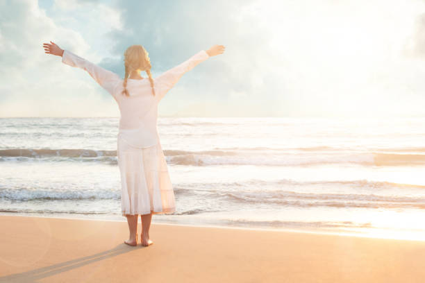 istock Beautiful Girl Resting on the Beach in the Sunlight. Happiness and Dreams 1192483708