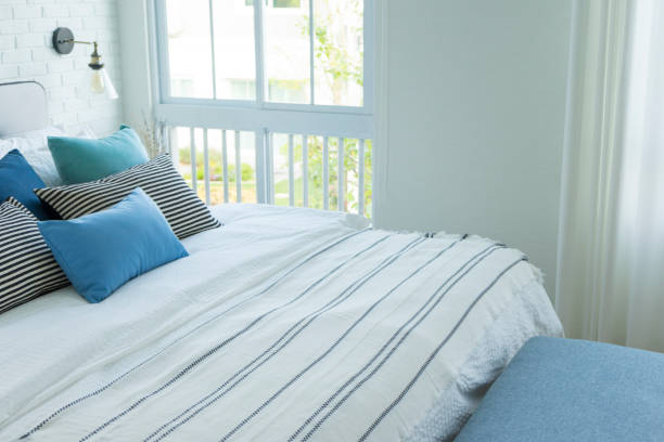 istock White and blue pillow on comfy bed in modern bedroom. 1192483789