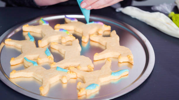 istock Decorating unicorn sugar cookies with royal icing. 1192484224