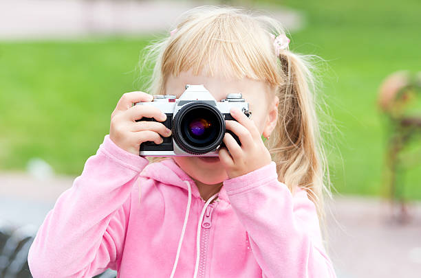 istock Little girl with the camera 119248572
