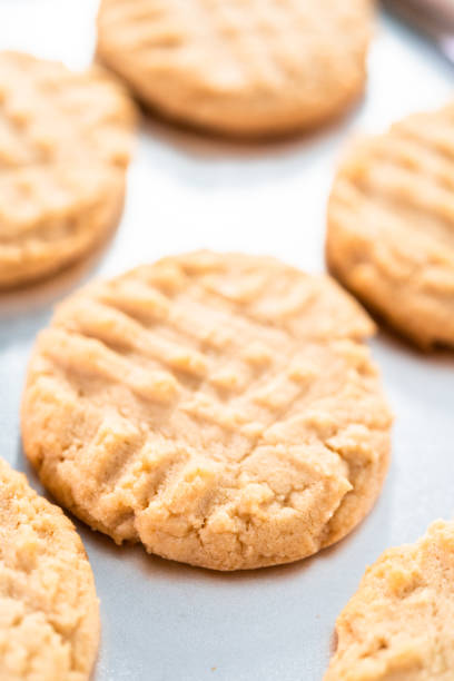istock Freshly baked peanut butter cookies on a baking sheet. 1192487107