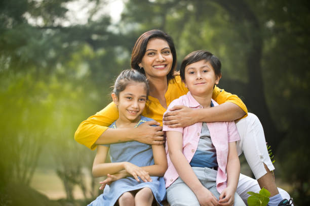 istock Happy mother with children at park 1192488948