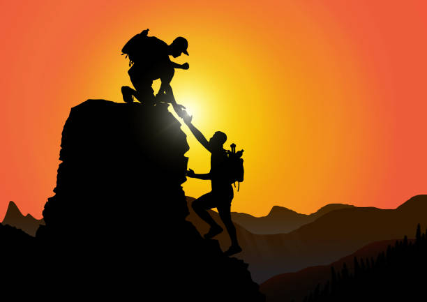 istock Silhouette of two people climbing mountain helping each other on rocky mountains with sunrise background, helping hand and assistance concept vector illustration 1192489325
