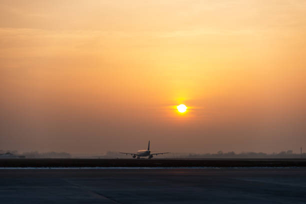 Airplane ready to take off at the sunrise