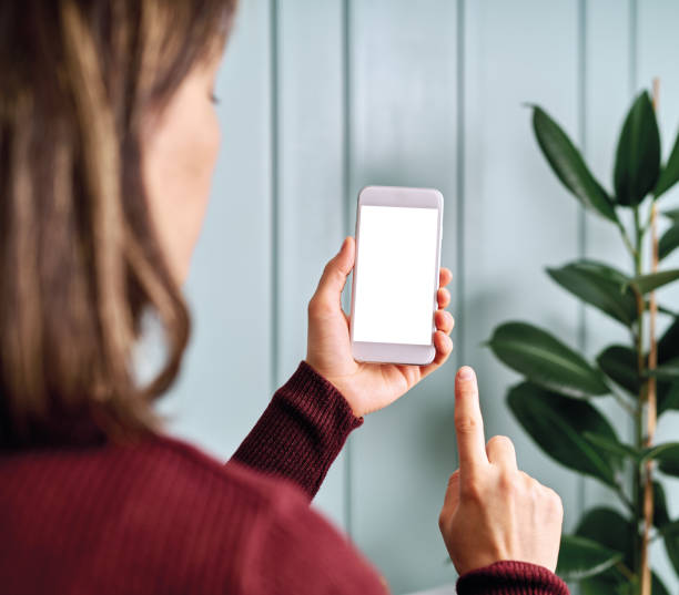 istock Woman holding and touching blank screen template smart phone. Smart phone screen is empty with clipping path. 1192491598