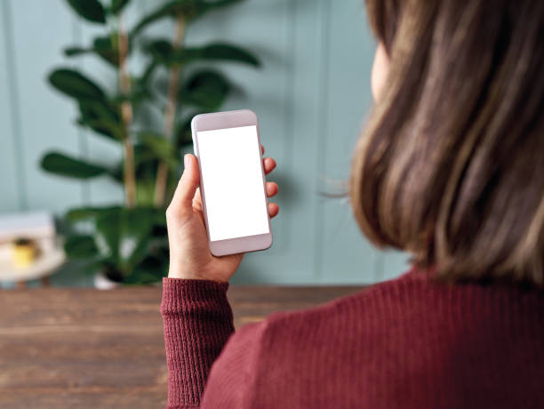istock Woman holding and touching blank screen template smart phone. Smart phone screen is empty with clipping path. 1192491622