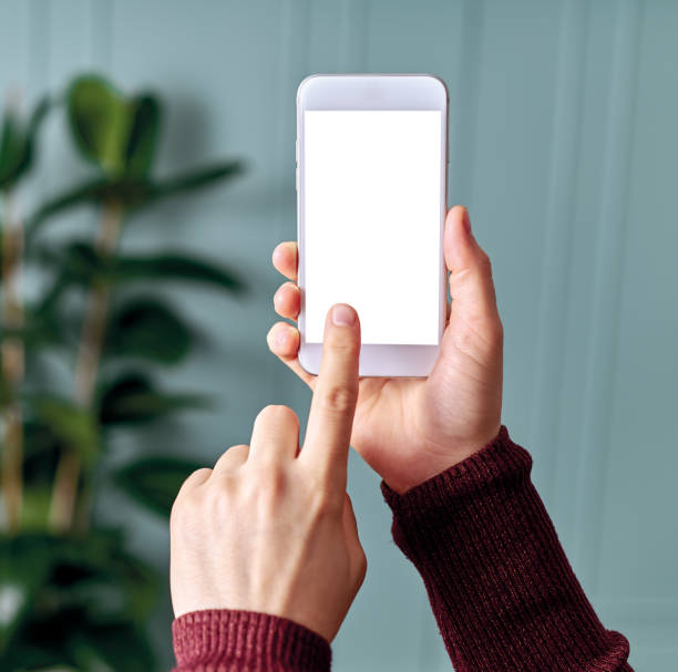 Woman holding and touching blank screen template smart phone. Smart phone screen is empty with clipping path.