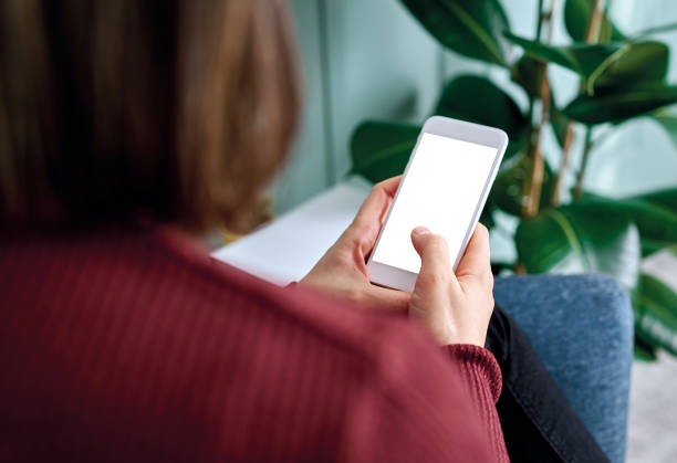 istock Woman holding and touching blank screen template smart phone. Smart phone screen is empty with clipping path. 1192491699