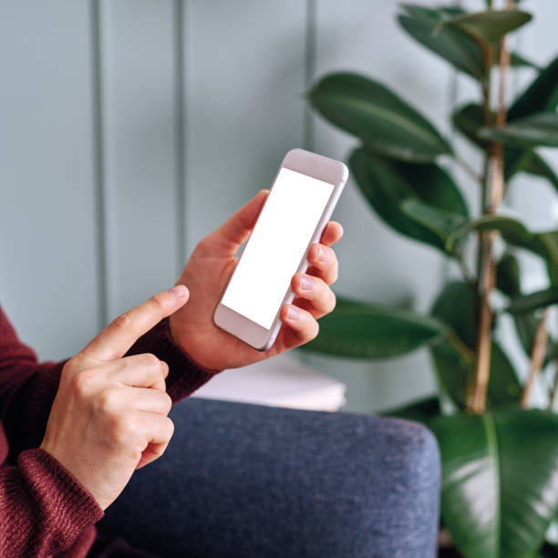 istock Woman holding and touching blank screen template smart phone. Smart phone screen is empty with clipping path. 1192491706