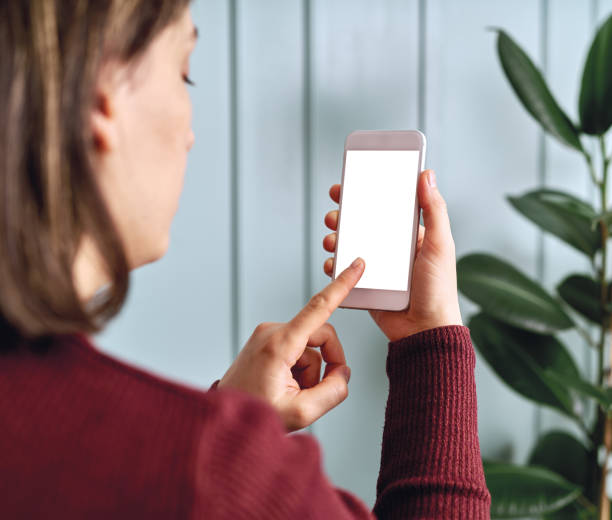 istock Woman holding and touching blank screen template smart phone. Smart phone screen is empty with clipping path. 1192491783