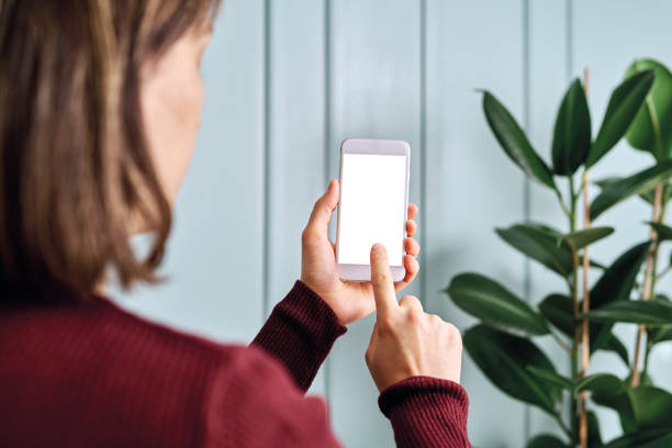 istock Woman holding and touching blank screen template smart phone. Smart phone screen is empty with clipping path. 1192491803