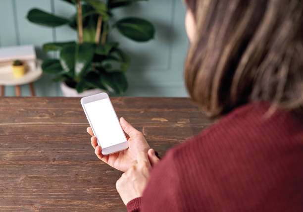 istock Woman holding and touching blank screen template smart phone. Smart phone screen is empty with clipping path. 1192491813
