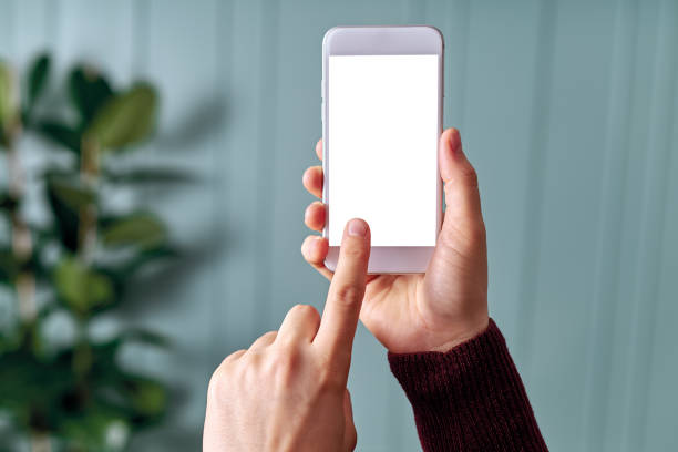 istock Woman holding and touching blank screen template smart phone. Smart phone screen is empty with clipping path. 1192491818