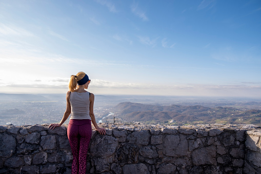 Adult woman hiking: border mountain of Italy and Slovenia. Europe.