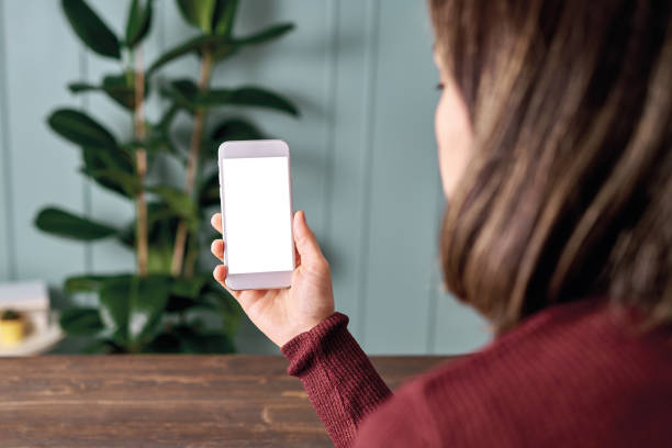 istock Woman holding and touching blank screen template smart phone. Smart phone screen is empty with clipping path. 1192492143
