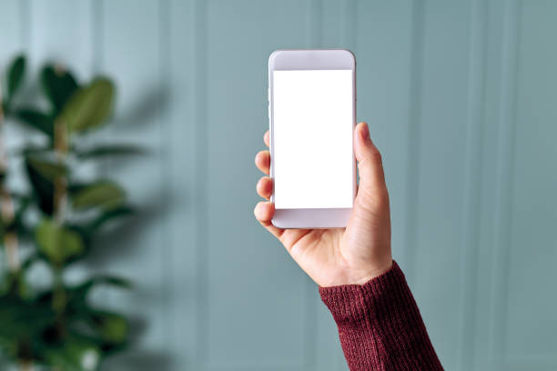 istock Woman holding and touching blank screen template smart phone. Smart phone screen is empty with clipping path. 1192492151