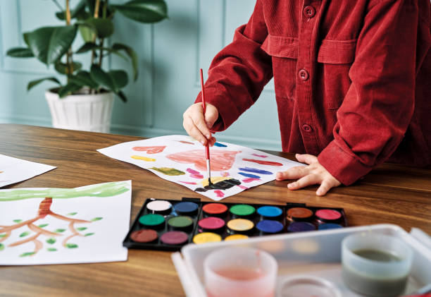 2-3 years child painting with watercolor at home. - brushing human hand paintbrush artist imagens e fotografias de stock