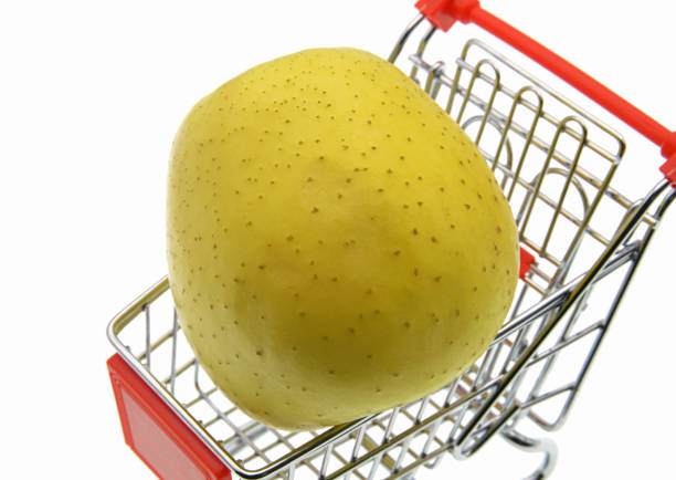 yellow apple in shopping cart isolated on white background