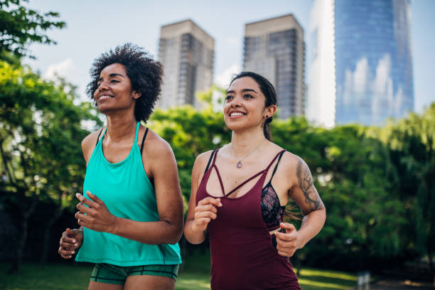 istock Beautiful young women running in park. 1192496927
