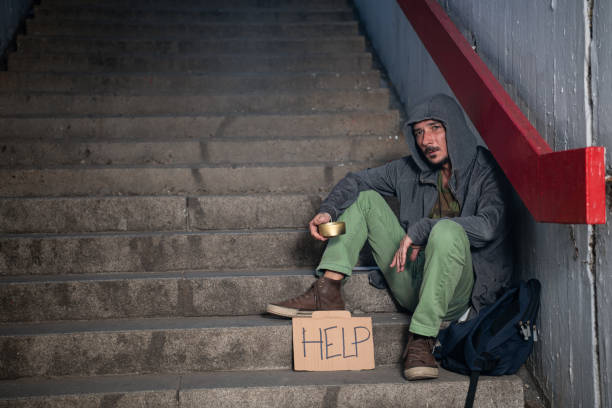 istock Lonely and Unhappy Man Begging for Help at the Street 1192497176