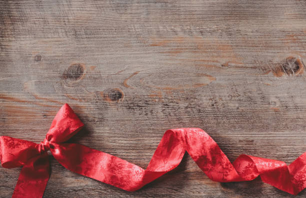 istock red ribbon on wood 1192497540