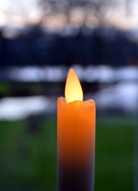 istock One artificial candle against a view of sunset 1192499150