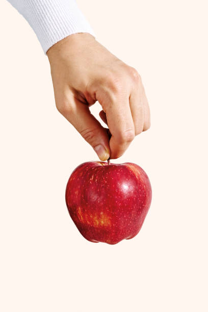 istock Woman hand holding apple fruit. 1192499595