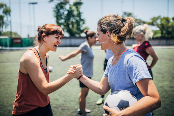 istock Women handshake on a soccer playing field 1192500779