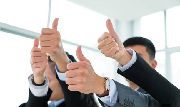 istock Business colleagues showing thumb up at office 1192500801