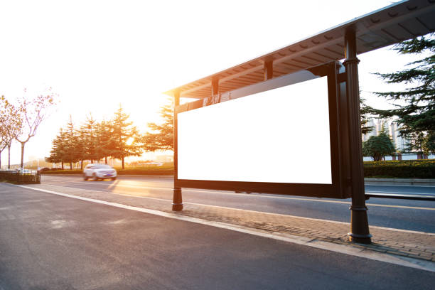 Bus stop with blank billboard at sunset Bus stop with blank billboard at sunset. bus shelter stock pictures, royalty-free photos & images