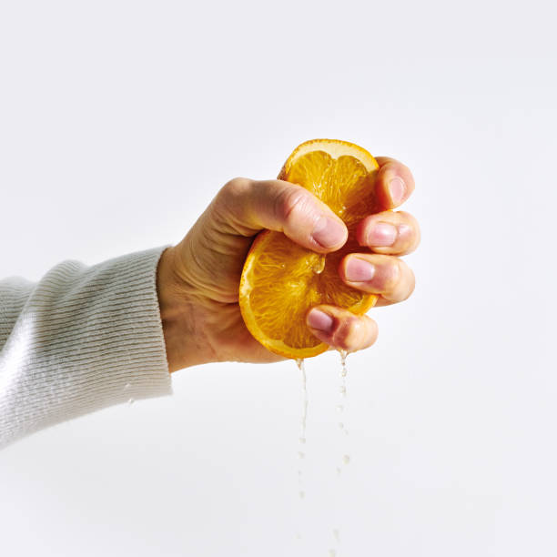 istock Woman hand holding orange fruit. 1192500936
