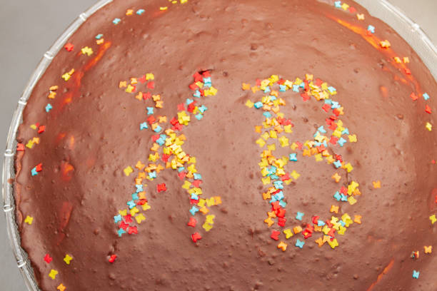 istock Chocolate cake at Easter with inscription of HV with colored sprinkles. 1192504710