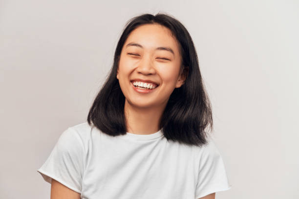 istock Positive young cheerful female closing eyes laugh 1192505963