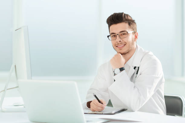 istock doctor therapist sitting at a table in his office 1192507118