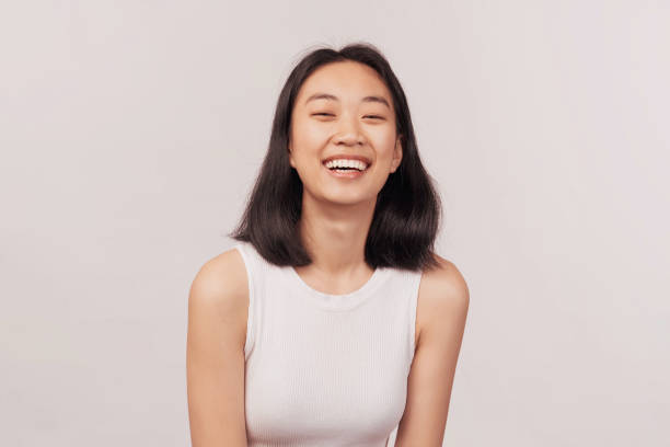 Girl laughs at something funny closes eyes