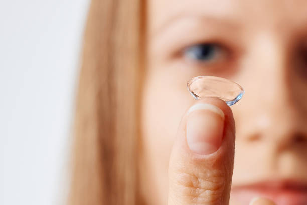 istock Woman holding contact lens 1192508481