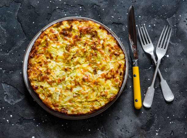 Leeks, potatoes, zucchini tortilla on a dark background, top view. Delicious appetizer, tapas, breakfast Leeks, potatoes, zucchini tortilla on a dark background, top view. Delicious appetizer, tapas, breakfast frittata stock pictures, royalty-free photos & images