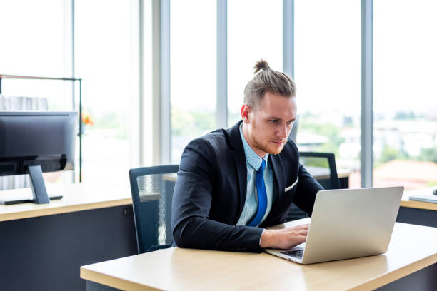 istock Businessman is working at the desk with a serious face 1192508828