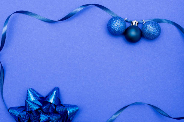 istock frame made with bright christmas baubles on classic blue background, copy space. greeting card 1192509069