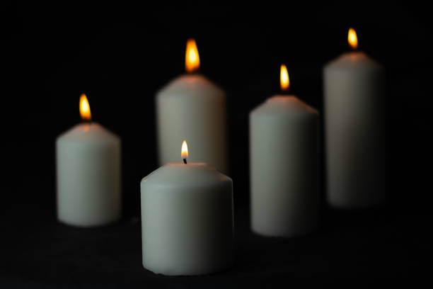 istock Five light flame candle burning brightly on black background 1192510956
