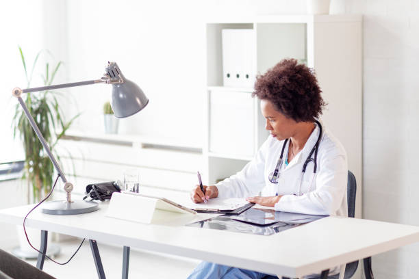istock Woman doctor write diagnose in document in ambulance office 1192514266