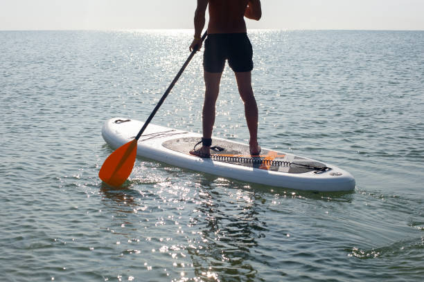 istock SUP silhouette sports man paddle boarding at sunset 1192514332