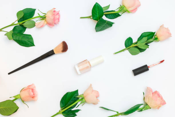 istock Pastel composition with pink roses and decorative cosmetics on white background. Flat lay, top view 1192514518