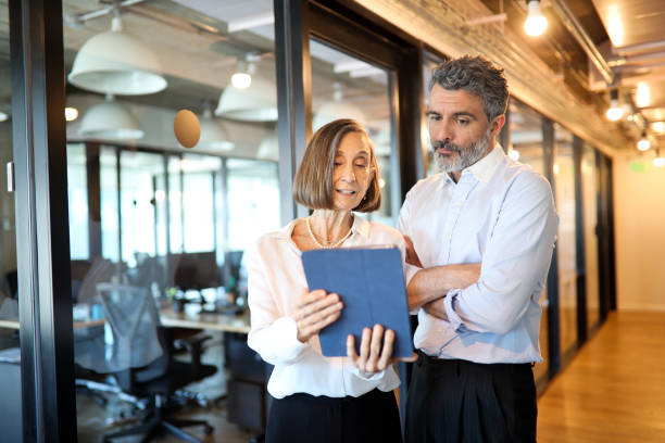 istock Business man and woman reviewing some documents 1192515524
