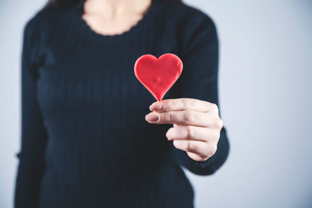 istock woman hand red heart 1192516549