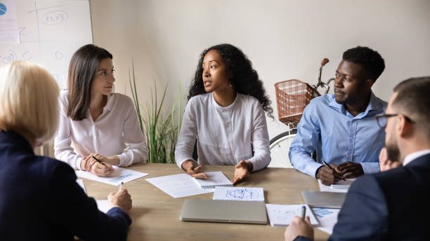 istock Mixed race motivated international coworkers discussing project. 1192516623