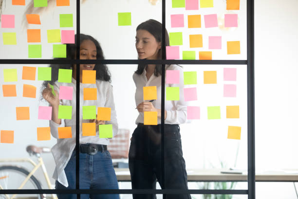 istock Mixed race managers working together near kanban board. 1192516659