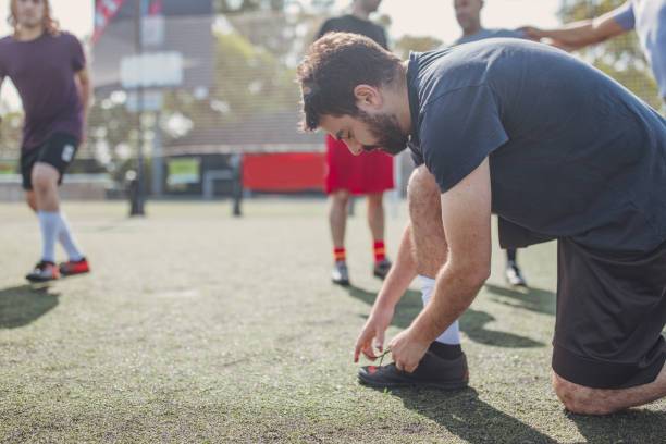 istock Male soccer player tying shoelace 1192517853