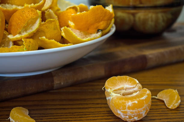 istock Peeled tangerines and peel on a plate on the table 1192525343